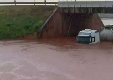 Carreta bitrem fica quase submersa embaixo de viaduto na BR-163